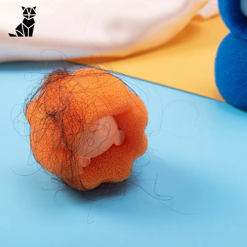 Brosse Anti-Peluche pour Machine à Laver - Petite balle orange sur une surface bleue